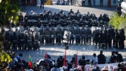 Police officers stand guard during a protest over the government's handling of the coronavirus disease (COVID-19) pandemic, in Bangkok, Thailand, Aug. 16, 2021.