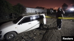 A man stands at the scene after two successive blasts in the residential area of Eastleigh Estate in Nairobi, Kenya, October 12, 2012. 