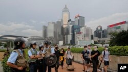 Riot police stand guard as protesters walk outside the Legislative Council in Hong Kong, June 13, 2019. 