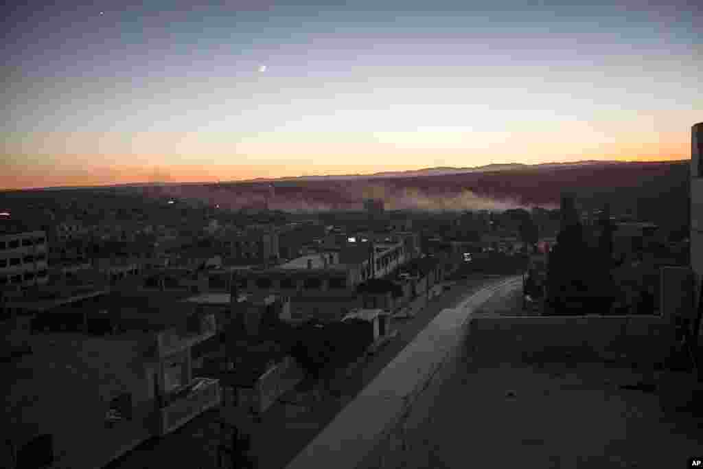Smoke rises from a mortar shell impact during heavy fighting between opposition fighters and the Syrian army at the frontline in Maaret al-Numan in Idlib province, Syria, Oct. 7, 2013. 
