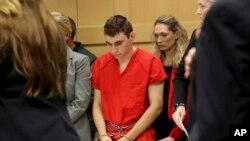FILE - Nikolas Cruz appears in court for a status hearing before Broward Circuit Judge Elizabeth Scherer in Fort Lauderdale, Fla., Feb. 19, 2018.