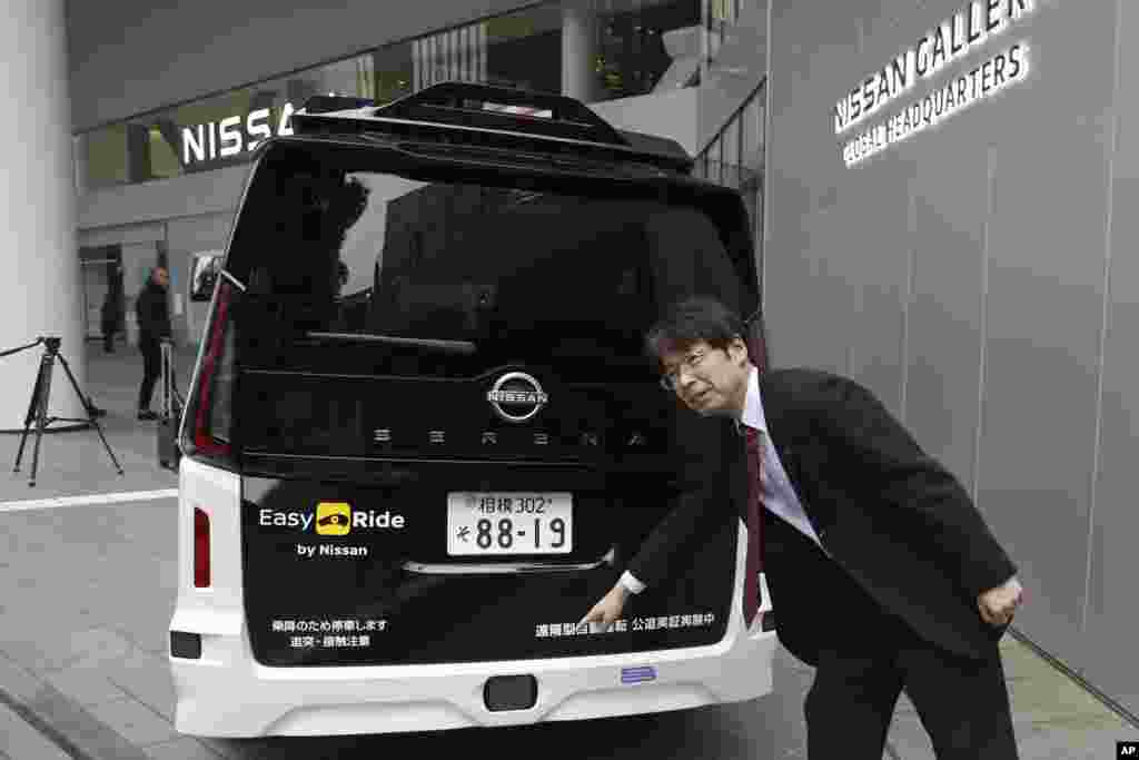 Takeshi Kimura, a Nissan engineer overseeing the Japanese automaker’s self-driving technology, shows the car to reporters at Nissan headquarters in Yokohama, on March 6, 2025. (AP Photo/Yuri Kageyama)