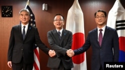 U.S. Ambassador Sung Kim, Japan's Representative Funakoshi Takehiro, and South Korea's Representative Kim Gunn prepare to pose for photographs before their meeting at the Foreign Ministry in Tokyo, Japan on September 7, 2022. (Kazuhiro NOGI/Pool via REUTERS)