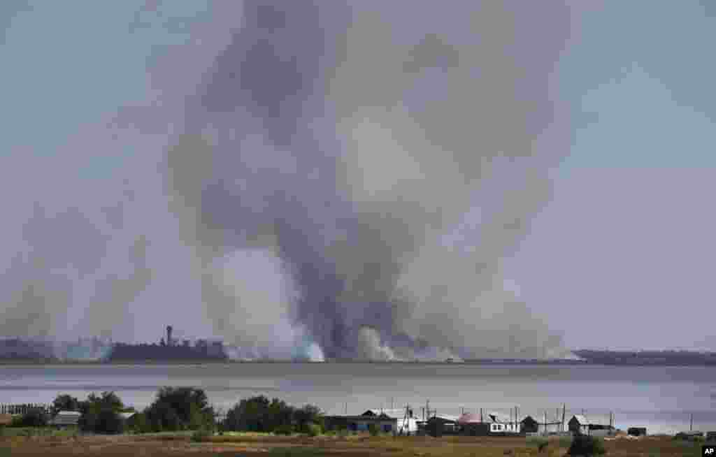 Smoke rises after shelling in the town of Novoazovsk, eastern Ukraine, Aug. 26, 2014.