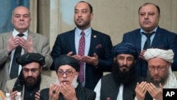 Taliban political chief Sher Mohammad Abbas Stanikzai, first row second from left, Abdul Salam Hanafi and other Taliban official pray during the "intra-Afghan" talks in Moscow, Russia, Wednesday, Feb. 6, 2019.