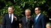 Chinese Vice Premier Liu He, center, flanked by U.S. Trade Representative Robert Lighthizer, left, and Treasury Secretary Steven Mnuchin, gestures to the media before a ministerial-level trade meeting in Washington, Oct. 10, 2019. 