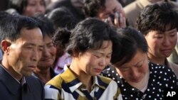 Families of victims of an accident at an apartment construction site in Pyongyang, North Korea, grieve during a gathering in the capital where senior officials apologized and took responsibility, May 17, 2014.