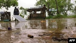 Two Myanmar policemen man a checkpoint at the entrance of Yathae Taung township in Rakhine State, Aug. 26, 2017.