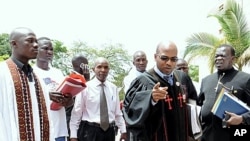 Pastor Martin Ssempa (pointing) and Julius Oyet arrive at the Ugandan Parliament to discuss the Anti-Homosexuality Bill, April 6, 2011
