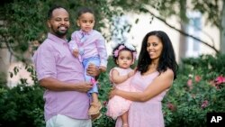 This Aug. 22, 2020, photo, provided by Yohannes Yirdaw shows Habtom Gezhey in Jacksonville, Fla., with his wife, Eyerusalem, their son Natanem and daughter Blen. Gezhey, a resettled refugee from Eritrea who has since become a U.S. citizen and plans to vot