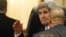 U.S. Secretary of State John Kerry, set to participate in talks on Syria, waves as he arrives at a hotel in Vienna, Nov. 13, 2015.