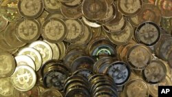 FILE - Bitcoin tokens 