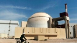 FILE - A worker rides a bicycle past the Bushehr nuclear power plant, just outside the southern city of Bushehr, Oct. 26, 2010. The official IRNA news agency reported, Feb. 1, 2024, that Iran is building four more new power plants in the port town of Sirik on the east coast.