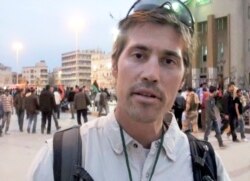 FILE - This undated file still image from video released April 7, 2011, by GlobalPost, shows James Foley of Rochester, N.H., a freelance contributor for GlobalPost, in Benghazi, Libya.