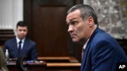 Kyle Rittenhouse, left, looks on as his attorney Mark Richards questions him as he testifies during his trial at the Kenosha County Courthouse, in Kenosha, Wisconsin, Nov. 10, 2021. 