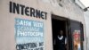 FILE - A Congolese internet cafe owner stands at the entrance of his empty business, in Kinshasa, Democratic Republic of Congo, Jan. 7, 2019.
