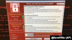 This image provided by the Twitter page of @fendifille shows a computer at Greater Preston CCG as Britain’s National Health Service is investigating “an issue with IT,” May 12, 2017. Hospitals, businesses and organizations around the world reported proble