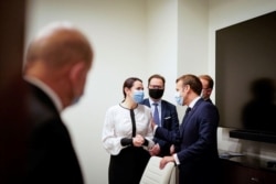 Belarusian opposition leader Sviatlana Tsikhanouskaya meets with French President Emmanuel Macron in Vilnius, Lithuania, Sept. 29, 2020.