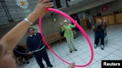 FILE - Patients with Alzheimer's and dementia are seen during a therapy session inside the Alzheimer Foundation in Mexico City.