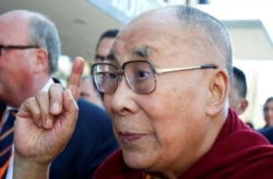 FILE -Tibetan spiritual leader the Dalai Lama gestures as he arrives at a hotel in Darmstadt, Germany, Sept. 18, 2018.