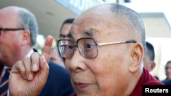 FILE PHOTO: Tibetan spiritual leader the Dalai Lama gestures as he arrives at a hotel in Darmstadt, Germany, Sept. 18, 2018. 