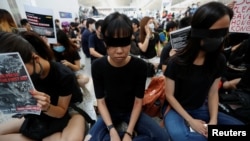 Anti-extradition bill demonstrators attend a protest at the departure hall of Hong Kong Airport, China August 12, 2019. REUTERS/Issei Kato