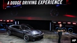 Tim Kuniskis, head of Dodge Brand talks about the company's Dodge Charger Daytona SRT concept during its unveiling, Wednesday, Aug. 17, 2022, in Pontiac, Mich. (AP Photo/Carlos Osorio)