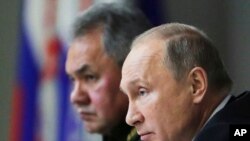 Putin and Shoigu attend a meeting while visiting the Military Academy of Strategic Rocket Troops of the Peter the Great, Balashikha, December 22, 2017.