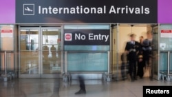 FILE - A flight crew arrives at Logan Airport in Boston, Massachusetts, June 29, 2017. The Trump administration has recently issued a revised travel ban affecting eight countries, including Chad. 