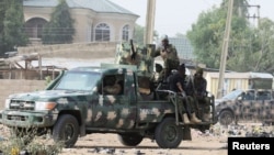 FILE - Nigerian military secure the area where a man was killed by suspected militants during an attack around Polo area of Maiduguri, Nigeria, Feb. 16, 2019. 