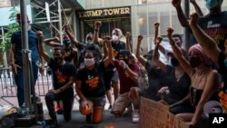 Protesters shout slogans against U.S. President Donald Trump during a protest outside Trump Tower on Fifth Avenue, July 4, 2020, in New York. 