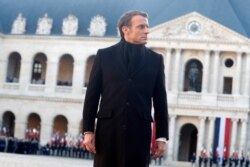French President Emmanuel Macron reviews the troops during a ceremony for the 13 French soldiers killed in Mali, Dec.2, 2019 at the Invalides monument in Paris.
