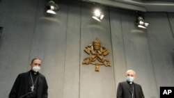 Mons. Filipp Iannone, right, and Mons. Juan Ignacio Arrieta Ochoa de Chinchetru at a press conference to illustrate changes in the Church's Canon law, at the Vatican, June 1, 2021.