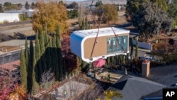 This photo provided by Mighty Buildings shows a 3D-printed house module being delivered in Livermore, Calif. Most modules are put together in a factory and then transported by truck to the owner’s property. (Courtesy of Mighty Buildings via AP)