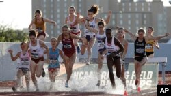 Runners compete in a preliminaries of the women's 3,000-meter steeplechase during the NCAA outdoor track and field championships in Austin, Texas, Thursday, June 6, 2019. (AP Photo/Eric Gay)