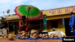 FILE - A vendor displays items for sale in the central market in Gorongosa, Mozambique, a country with great economic potential yet growing inequality and poverty.