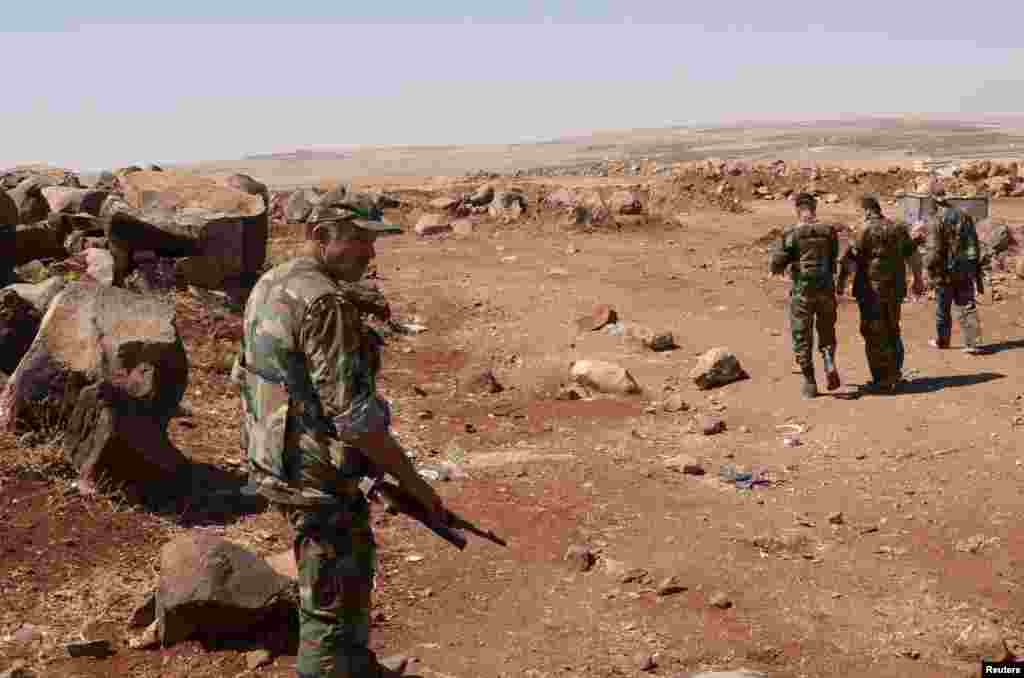 Forces loyal to Syria's President Bashar al-Assad are seen in Tal El-Tineh village outside Aleppo, Syria, June 16, 2013. 
