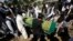 FILE - Afghans take part in a burial ceremony of Afghan journalist Zabihullah Tamanna, in Kabul, Afghanistan, June 7, 2016. 