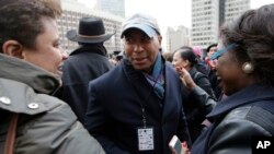 FILE - Former Massachusetts Governor Deval Patrick, center, greets people in a crowd, in Boston, Massachusetts, April 2, 2018.