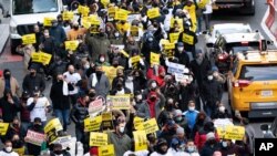 Restaurant and bar owners, employees and union workers march on 42nd Street in support of the restaurant industry, Dec. 15, 2020, in New York.