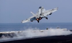 In this picture taken on Nov. 21, 2016, a U.S. Navy fighter jet takes off from the deck of the U.S.S. Dwight D. Eisenhower aircraft carrier.