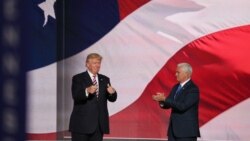 Republican presidential nominee Donald Trump, left, gives his running mate, Indiana Governor Mike Pence, a thumbs up after Pence addressed the Republican National Convention.