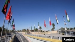 National flags of countries participating in the Arab League Summit are displayed along a street ahead of the summit in Algiers, Algeria Oct. 27, 2022. 