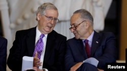 FILE - Senate Majority Leader Mitch McConnell, left, and Senate Minority Leader Chuck Schumer talk during a Capitol Hill ceremony in Washington, Oct. 25, 2017.