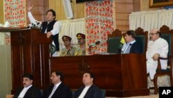 Pakistani Prime Minister Imran Khan addresses Kashmir's Legislative Assembly on the occasion of Pakistan's Independence Day, in Muzaffarabad, capital of Pakistani Kashmir, Aug. 14, 2019. He condemned New Delhi's decision to downgrade Kashmir's status. (AP Photo/M.D. Mughal)