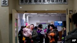 资料照片：家长和孩子在北京儿童医院的候诊室等候。（2016年12月18日）