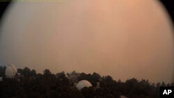 This photo provided by High Performance Wireless Research and Education Network and ALERTWildfire from a camera atop Mount Wilson shows dense smoke shrouding the famed Southern California observatory, Sept. 16, 2020.