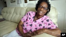 FILE - Gwen Strowbridge, 71, poses for a photograph wearing her work uniform at her home in Deerfield Beach, Florida, Oct. 18, 2016. Strowbridge has worked all her life and plans to work until she can't physically work anymore.