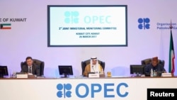 Kuwait Oil Minister Ali Al-Omair gives his opening speech during OPEC 2nd Joint Ministerial Monitoring Committee meeting as Russian Energy Minister Alexander Novak and OPEC Secretary-General Mohammad Barkindo attend the meeting in Kuwait City, Kuwait, March 26, 2017,