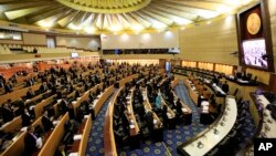 Thailand's legislature, known as the National Reform Council, stands after they vote 135-105, with seven abstentions, against a new draft constitution in Bangkok, Thailand, Sept. 6, 2015.